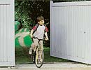 Boy withbicycle at a gate